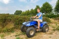 Young man driving quad in nature