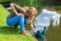 Young dutch woman filling green caster with water