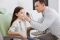 Young ear nose throat doctor doing hearing exam of girl Royalty Free Stock Photo