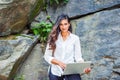 Young East Indian American Woman with long hair working on laptop computer outdoor in New York