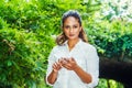 Young East Indian American Woman texting on cell phone outdoor at Central Park, New York Royalty Free Stock Photo