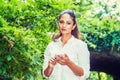 Young East Indian American Woman texting on cell phone outdoor at Central Park, New York Royalty Free Stock Photo