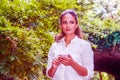 Young East Indian American Woman texting on cell phone outdoor at Central Park, New York Royalty Free Stock Photo