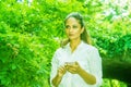 Young East Indian American Woman texting on cell phone outdoor at Central Park, New York Royalty Free Stock Photo