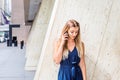 Young Eastern European American Woman talking on cell phone outside in New York City Royalty Free Stock Photo