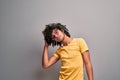 Young eastern man playfully touching his healthy beautiful curly hair Royalty Free Stock Photo