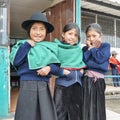 Young Ecuadorian indigenous schoolgirls pose for a picture outside their school