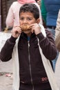 Young Egyptian boy eating roasted ear of corn at Khan Al-Khalili market in Cairo, Egypt.