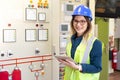 Young businesswoman standing in front of the control panel in the control room Royalty Free Stock Photo