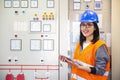 Young businesswoman standing in front of the control panel in the control room Royalty Free Stock Photo