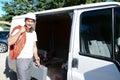 Young electrician artisan taking tools out of professional truck van Royalty Free Stock Photo