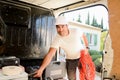 Young electrician artisan taking tools out of professional truck van Royalty Free Stock Photo