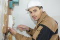 Young electrician builder engineer installing fuse box Royalty Free Stock Photo