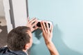 A young electrician installing an electrical socket in a new house. Royalty Free Stock Photo