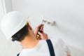 A young electrician installing an electrical socket in a new house Royalty Free Stock Photo