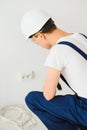 A young electrician installing an electrical socket in a new house Royalty Free Stock Photo