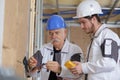 Young electrician and senior supervisor at work Royalty Free Stock Photo