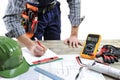 Young electrician technician analyzes the project of a residential building Royalty Free Stock Photo