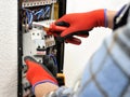 Young electrician technician at work on a electrical panel with Royalty Free Stock Photo