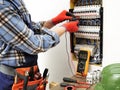 Young electrician technician at work on a electrical panel with Royalty Free Stock Photo