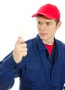 Young electrician in uniform with bulb. Royalty Free Stock Photo