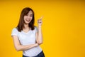 Young elegant Asian woman smiling and pointing to empty copy space Royalty Free Stock Photo