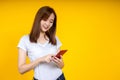 Young elegant Asian woman smiling and using chat or emailing on smartphone Royalty Free Stock Photo