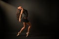 Young elegant ballet dancer, dressed in black jersey, shoes and weightless black skirt is demonstrating ability to dance.