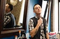 Barber invites to have seat on chair at barbershop