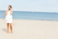 Young elegant beautiful woman talking on the phone on the beach Royalty Free Stock Photo