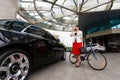 Young elegant business woman with bicycle and car Royalty Free Stock Photo