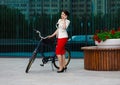 Young elegant business woman with bicycle Royalty Free Stock Photo