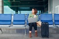 Young elegant business woman in international airport terminal, working on her laptop while waiting for flight Royalty Free Stock Photo