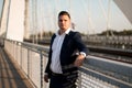 Young elegant businessman standing on a bridge by the railroad Royalty Free Stock Photo