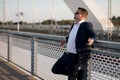 Young elegant businessman standing on a bridge by the railroad Royalty Free Stock Photo