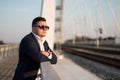 Young elegant businessman standing on a bridge by the railroad Royalty Free Stock Photo