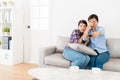 Young elegant female friends watching tv together Royalty Free Stock Photo