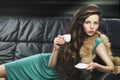 Young elegant girl in green with cup,