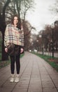 Young elegant girl in park during autumn