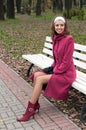 Young elegant girl in purple coat