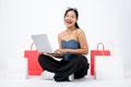 Young elegant and happy Asian woman enjoying using online shopping website on her laptop computer Royalty Free Stock Photo