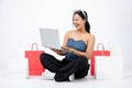 Young elegant and happy Asian woman enjoying using online shopping website on her laptop computer Royalty Free Stock Photo