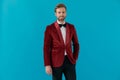 Young elegant man wearing red velvet tuxedo and smiling Royalty Free Stock Photo