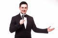Young elegant talking man holding microphone and present invisible product. Royalty Free Stock Photo