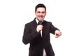 Young elegant talking man holding microphone talking with pointing finger. Royalty Free Stock Photo