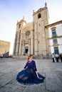 Young elegant woman in blue long flying dress posing at stairway against old city building Royalty Free Stock Photo