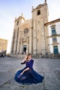 Young elegant woman in blue long flying dress posing at stairway against old city building Royalty Free Stock Photo