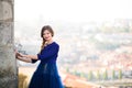 Young elegant woman in blue long flying dress posing at stairway against old city building Royalty Free Stock Photo