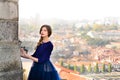 Young elegant woman in blue long flying dress posing at stairway against old city building Royalty Free Stock Photo