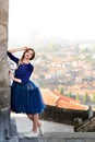 Young elegant woman in blue long flying dress posing at stairway against old city building Royalty Free Stock Photo